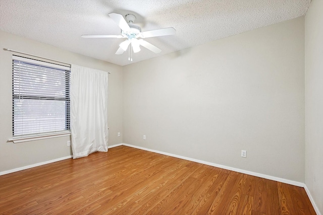 unfurnished room featuring hardwood / wood-style flooring, ceiling fan, and a textured ceiling