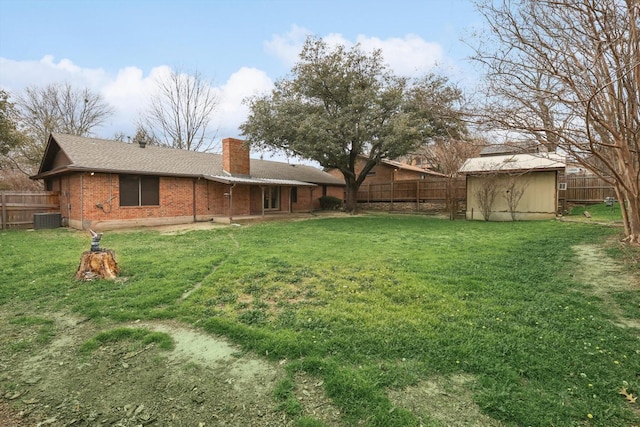 view of yard with cooling unit and a shed