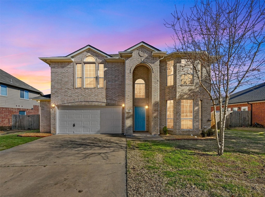 view of front facade featuring a garage and a lawn