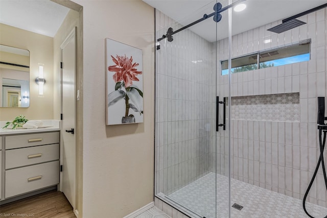 bathroom with an enclosed shower, hardwood / wood-style floors, and vanity