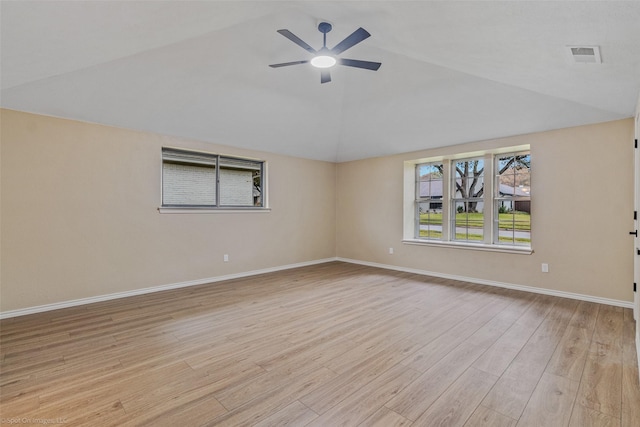 empty room featuring lofted ceiling, ceiling fan, and light hardwood / wood-style flooring