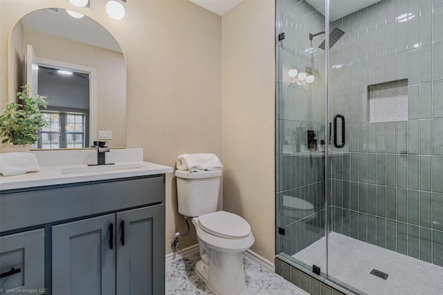 bathroom featuring an enclosed shower, vanity, and toilet