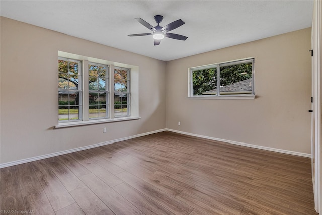 spare room with hardwood / wood-style flooring and ceiling fan