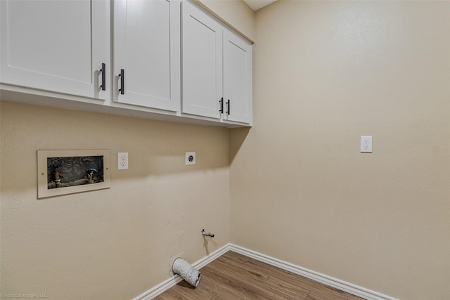 washroom featuring hardwood / wood-style floors, cabinets, hookup for a gas dryer, washer hookup, and hookup for an electric dryer