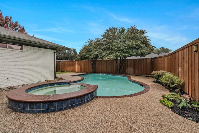 view of swimming pool featuring an in ground hot tub and a patio area