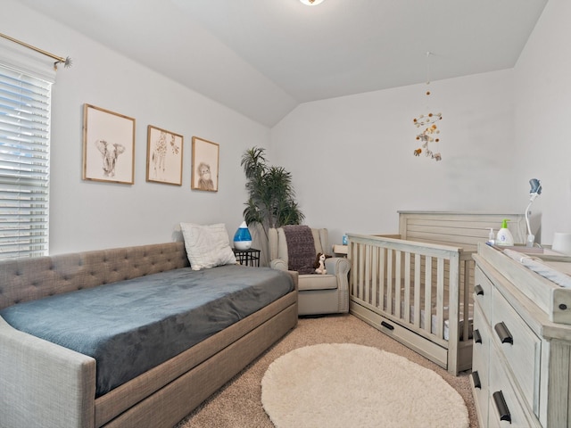 carpeted bedroom with vaulted ceiling