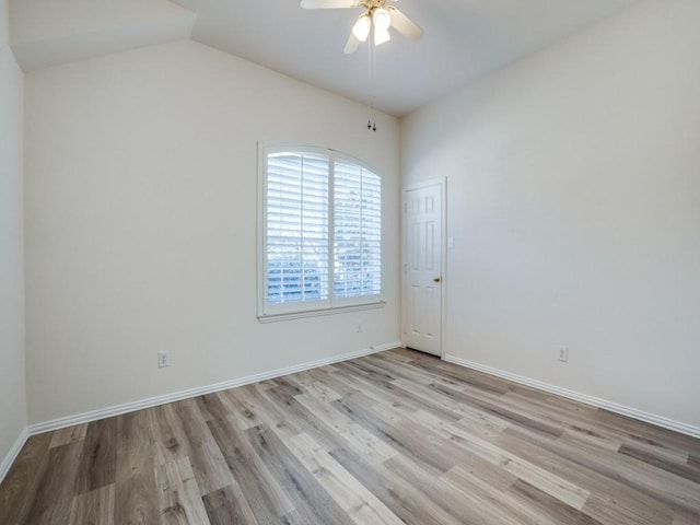 spare room featuring lofted ceiling, ceiling fan, and light hardwood / wood-style flooring