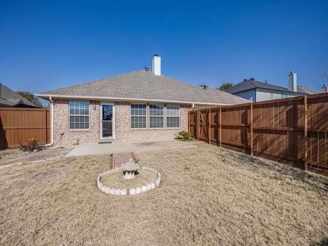 rear view of property with a patio area and a lawn