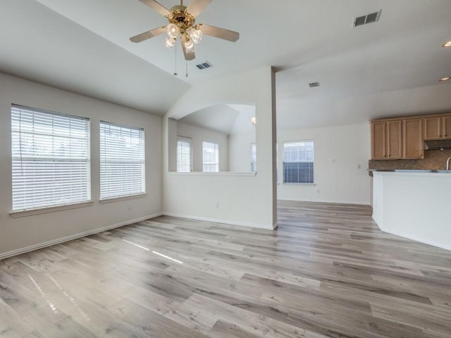 unfurnished living room featuring vaulted ceiling, ceiling fan, and light wood-type flooring