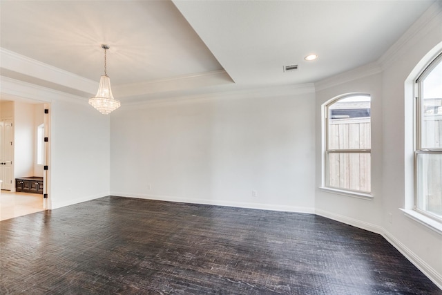 unfurnished room with a wealth of natural light, ornamental molding, and a chandelier