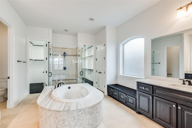 full bathroom featuring vanity, tile patterned flooring, independent shower and bath, and toilet