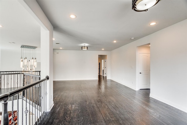 unfurnished room with dark wood-type flooring