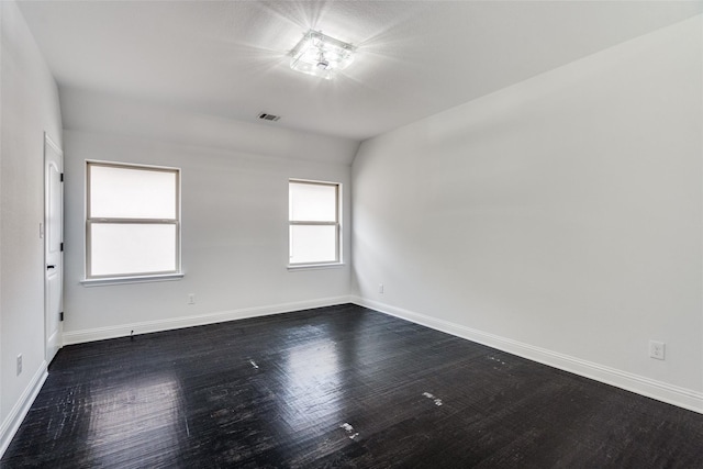 unfurnished room with lofted ceiling