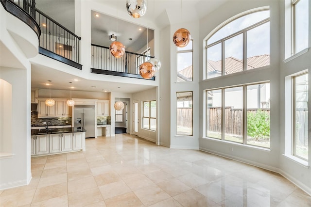 unfurnished living room with a high ceiling