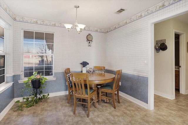 dining area featuring a notable chandelier