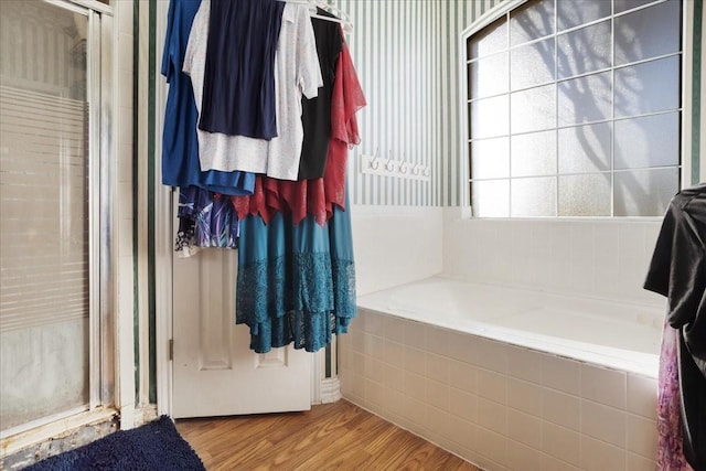 bathroom featuring hardwood / wood-style flooring and independent shower and bath