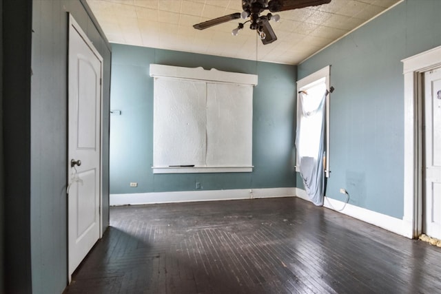 unfurnished bedroom with dark hardwood / wood-style flooring and ceiling fan