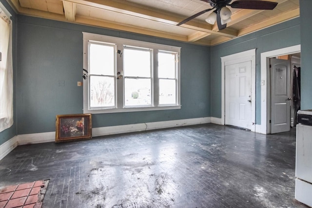 empty room with beamed ceiling, coffered ceiling, and ceiling fan