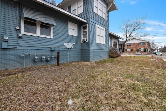 view of side of home featuring a lawn