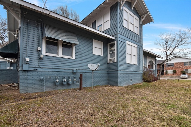 view of side of home featuring a yard