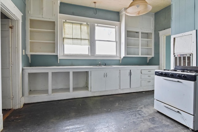 kitchen with white range with gas cooktop, sink, and white cabinets