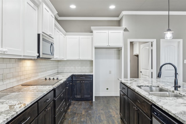 kitchen featuring sink, decorative backsplash, black appliances, and white cabinets