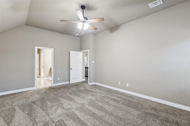 unfurnished bedroom featuring carpet, lofted ceiling, and ceiling fan