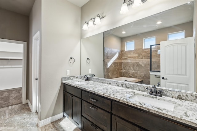 bathroom with vanity and a tub