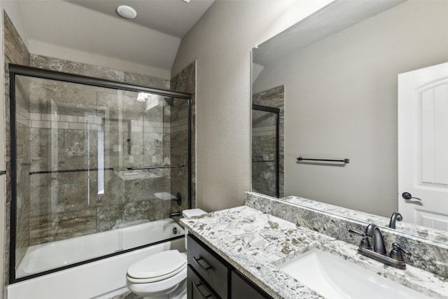 full bathroom featuring bath / shower combo with glass door, vanity, vaulted ceiling, and toilet