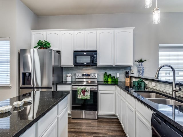 kitchen with white cabinetry, sink, hanging light fixtures, and black appliances