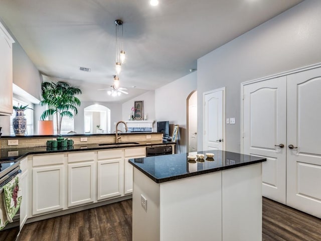 kitchen with pendant lighting, white cabinetry, and sink