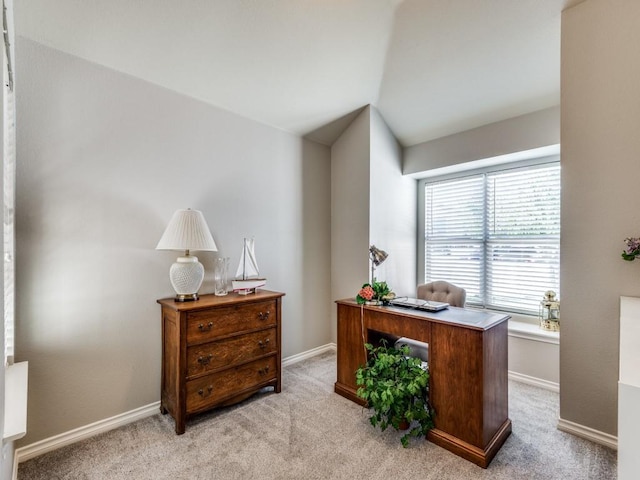 carpeted office space featuring vaulted ceiling