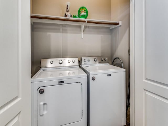 clothes washing area with washing machine and clothes dryer