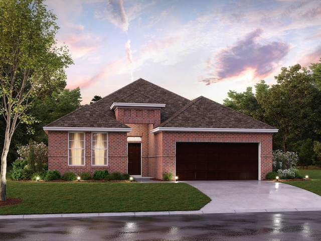 view of front facade with a garage and a yard