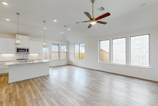 5208 Greenbrook Rd, Denton, TX 76226 - kitchen with stainless steel microwave, ceiling fan, light countertops, open floor plan, and decorative backsplash