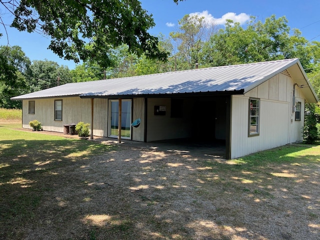 rear view of house featuring a yard