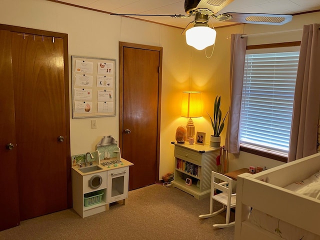 bedroom featuring crown molding, ceiling fan, and carpet flooring