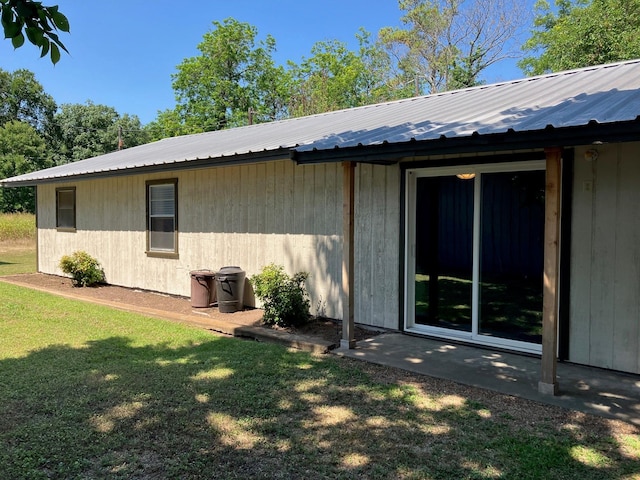 back of house with a lawn