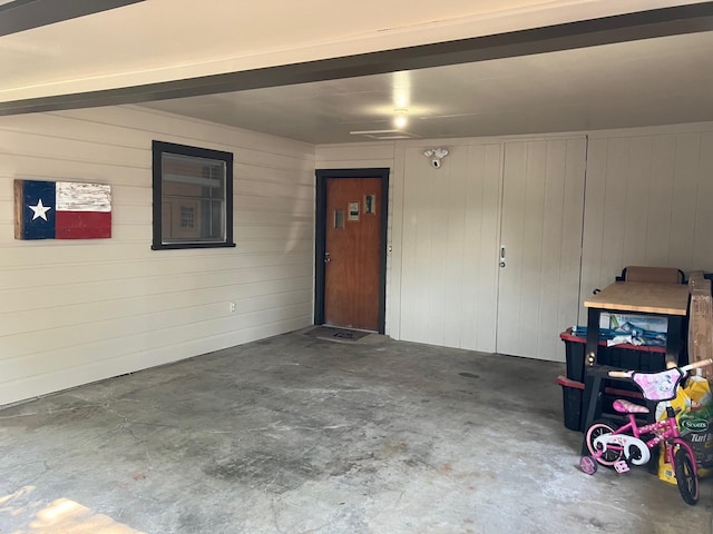 garage featuring wooden walls