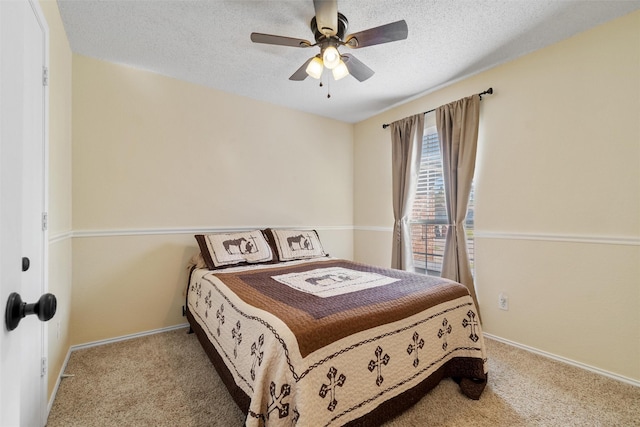 bedroom featuring carpet floors, a textured ceiling, and ceiling fan