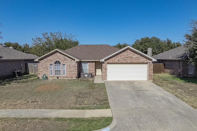 ranch-style home with a garage and a front lawn