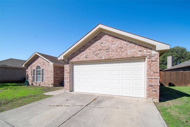 view of front of home featuring a garage and a front yard