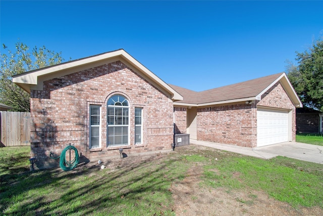 ranch-style home featuring a garage and a front lawn