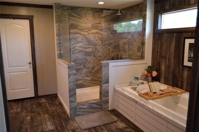 bathroom with independent shower and bath and hardwood / wood-style flooring