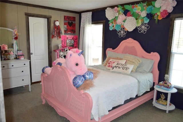 bedroom featuring crown molding and dark carpet