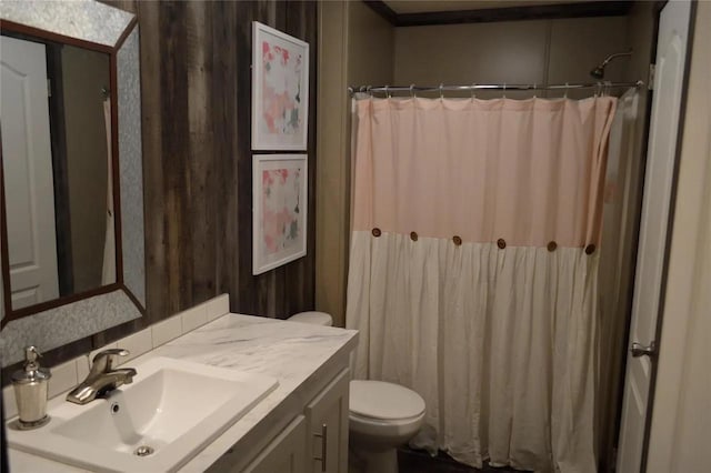 bathroom with vanity, walk in shower, and toilet