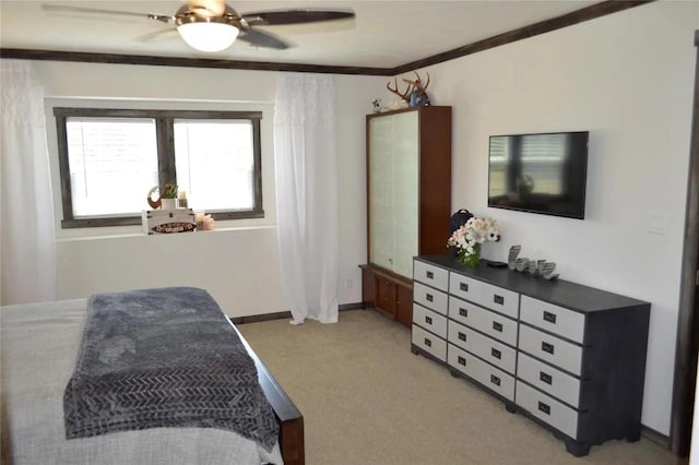 bedroom featuring crown molding, ceiling fan, and light carpet