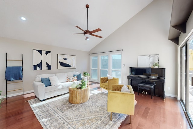 living room with ceiling fan, high vaulted ceiling, a wealth of natural light, and dark hardwood / wood-style flooring