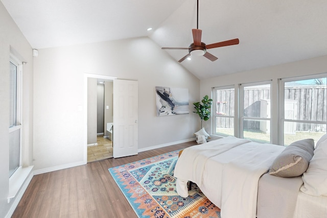 bedroom featuring hardwood / wood-style flooring, ceiling fan, and lofted ceiling