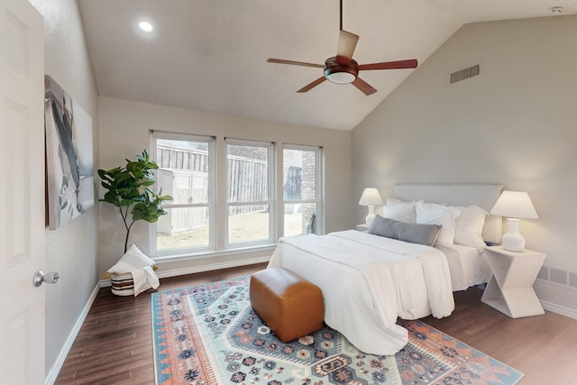 bedroom featuring lofted ceiling, dark wood-type flooring, and ceiling fan